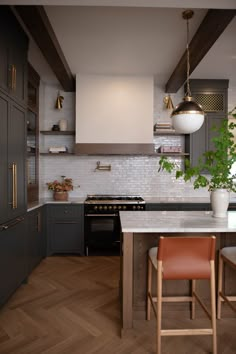 a kitchen with wooden floors and gray cabinets