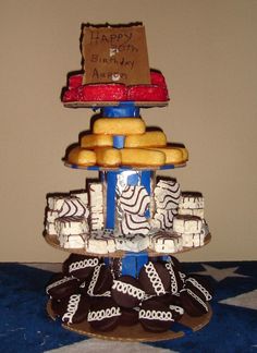 a birthday cake made to look like a train on top of other cakes and pastries