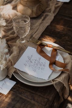 a table set with white plates and silverware