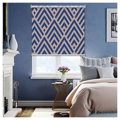 a bed room with a neatly made bed and a window covered in blue roman shades