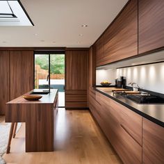 a modern kitchen with wooden cabinets and black counter tops, along with an open floor plan