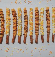 several skewered sausages are lined up on a white surface