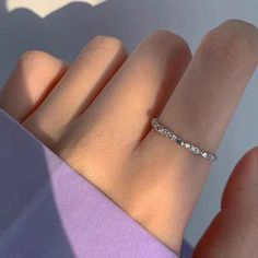 a woman's hand with a diamond ring on it