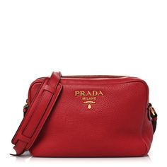 This is an authentic PRADA Vitello Phenix Camera Bag in Rosso. This stunning crossbody bag is finely crafted of textured calfskin leather in red. The bag features an adjustable crossbody strap with silver hardware. The top opens to a black Prada logo jacquard interior with a zipper pocket. Prada Camera Bag, Red Prada Bag, Luxury Red Bag With Zipper Pocket, Red Crossbody Bag For On-the-go, High-end Red Crossbody Shoulder Bag, Zipper Pocket, Camera Bag, Calf Skin, Prada