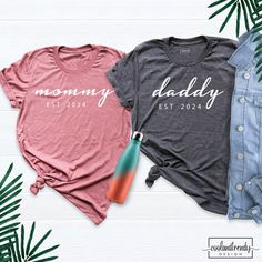 Mommy and Daddy Shirt. Baby Announcement Tshirt, Custom Est Mom and Dad Matching Shirts, Pregnancy Reveal Shirt, New Mama Shirt, New Dad Tee. Hi! Welcome to our store. It's good to see you here. Our aim is to offer you first-class clothing in your most beautiful moments with our graphic t-shirts that we designed or designed with your ideas. I am sure you will like our designs for your family, friends and you. IMPORTANT MATTERS FOR ORDERING: 1-) Please check and review all photos. 2-) Our sizes a Mother's Day Crew Neck T-shirt, Family Matching Soft-washed Short Sleeve T-shirt, Family Matching Crew Neck Tops For Gender Reveal, Family Crew Neck Tops With Name Print, Pink Short Sleeve T-shirt For Family, Casual Pink Shirt For Family Occasions, Casual Shirt With Name Print For Gender Reveal, Casual Tops With Letter Print For Gender Reveal, Pink Short Sleeve Tops For Family