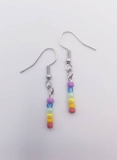 Rainbow Bead Pride Earrings Every pair is custom made upon request with irregular beads and no two pieces will be exactly the same, even in the same pair. Custom requests for any flag wanted are gladly accepted anytime! ️️ Pride Earrings, Pride Jewelry, Pride Jewellery, Earrings Colorful, Rainbow Beads, Rainbow Earrings, Pride Gifts, Bead Jewelry, Pride Month