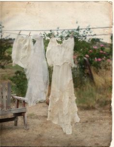 two white dresses hanging on a clothesline with the words,'the feminine home '