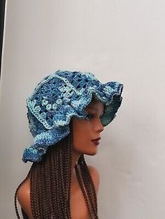 a woman wearing a blue hat with braids