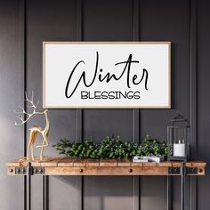 a wooden table topped with a plant next to a white sign that says winter blessing