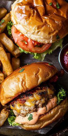 two burgers and fries on a tray with ketchup