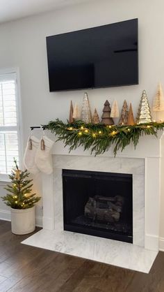 a fireplace decorated with christmas decorations and lights