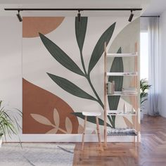 an orange wall mural with black and white flowers on it in a living room area