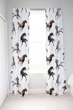 the curtains in this bedroom have horses printed on them and they are hanging next to each other