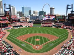 a baseball stadium with the st louis cardinals in it's center field and gateway arch