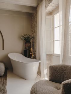 a white bath tub sitting next to a window