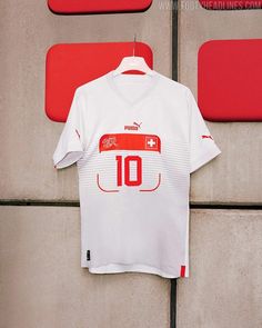 a soccer jersey hanging up against a wall