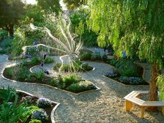 an image of a garden with trees and flowers on it's sides, surrounded by gravel