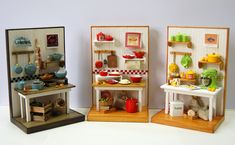 three small doll houses with different furniture and kitchen items in the same room, one on top of the other