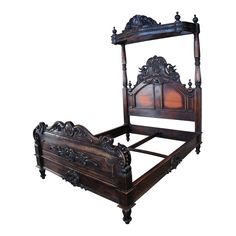 an antique wooden bed frame with intricate carvings