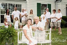 a group of people standing and sitting in front of a house