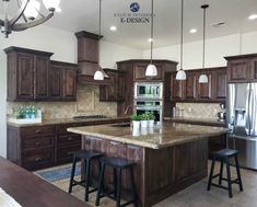 a large kitchen with an island in the middle and two stools at the end