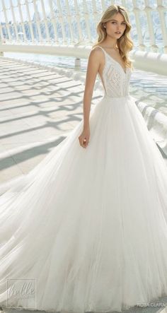 a woman in a white wedding dress posing for the camera