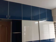 a kitchen with blue and white cabinets in it