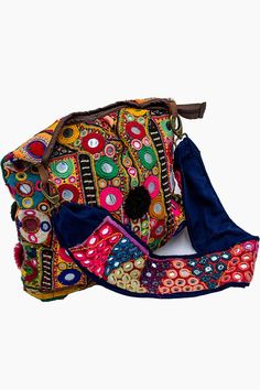 Introducing our Banjara Handbags collection, where tradition meets style. This particular piece is a Banjara Shoulder Bag, a perfect embodiment of Bohemian Chic Accessories. The bag is a riot of colors, featuring a rich tapestry of multicolored fabric. It’s adorned with intricate embroidery and mirror work, adding a touch of sparkle and whimsy. Playful pompoms further enhance its charm, making it a standout piece in any setting. What sets this bag apart is its craftsmanship. As part of our Handc Multicolor Bohemian Shoulder Bag For Travel, Traditional Multicolor Bag With Adjustable Strap, Multicolor Handmade Bags For Festivals, Handmade Multicolor Festival Bags, Handmade Multicolor Bags For Festivals, Bohemian Multicolor Travel Satchel, Traditional Bag With Multicolor Embroidery And Adjustable Strap, Multicolor Bohemian Bag With Adjustable Strap, Bohemian Multicolor Bag With Adjustable Strap