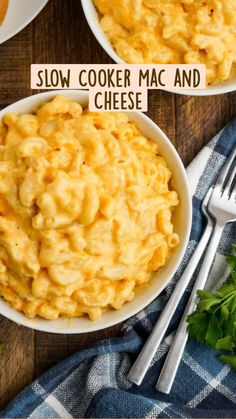 two white bowls filled with macaroni and cheese on top of a wooden table