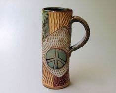 a coffee mug with a peace sign painted on it