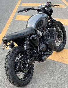 a black motorcycle parked in a parking lot