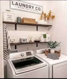 a washer and dryer in a laundry room with shelving above the washer