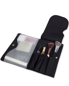 an open makeup bag with brushes and other items in it