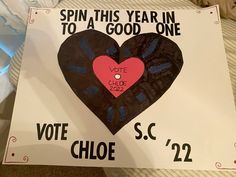 a sign that says spin this year in to a good one with a heart on it