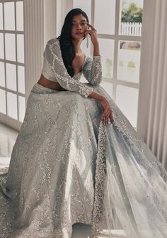 Enchant in this grey dupion silk embroidered lehenga featuring intricate mirror and zari detailing. Paired elegantly with a full-sleeve embroidered blouse and a tulle embroidered dupatta, this ensemble embodies grace and sophistication. Gray Lehenga, Mirror Lehenga, Grey Lehenga, Matching Embroidery, Full Sleeve Blouse, Zari Embroidery, Vacuum Storage, Embroidered Lehenga, Indian Wedding Wear