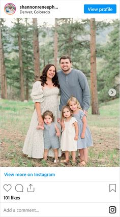 a family posing for a photo in the woods