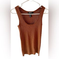 Add Some Sparkle To Your Wardrobe With This Metallic, Sleeveless Tank Top From Dkny. The Rust Color And Glitter Accents Make It Perfect For Any Occasion Whether It’s A Night Out Or A Casual Date. It Is Easy To Care For, And Can Be Born All Seasons. The Size Is Small And Has A Regular Fit Brown Sleeveless Tank Top For Night Out, Sleeveless Brown Tank Top For Night Out, Brown Sleeveless Camisole For Night Out, Casual Date, Rust Color, Sleeveless Tank Top, Sleeveless Tank, All Seasons, Night Out