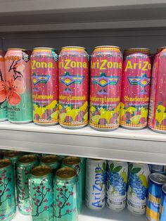 several cans of arizona ale are on display in a grocery store's cooler shelf