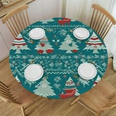 the table is set for christmas dinner with plates and silverware on it's placemats