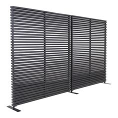 a black metal fence with horizontal slats on top and two poles attached to it