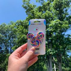 a person holding up a card with an image of a lollipop sucker on it