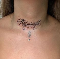 a woman with a tattoo on her neck that says, abundance above the word money