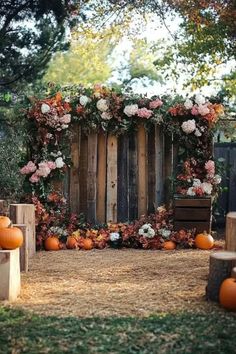 A rustic fall garden wedding backdrop decorated with pumpkins, floral accents, and wooden elements, perfect for an October wedding ceremony. Fall Wedding Decorations