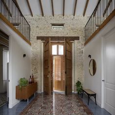 an entry way with wooden doors and tile flooring