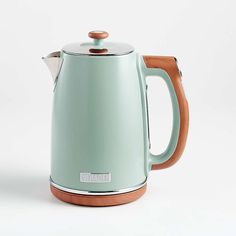 an electric tea kettle with wooden handle and lid on a white background, it appears to be used as a coffee pot