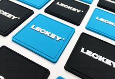 several blue and black square coasters with the words lucky on them, all in different languages