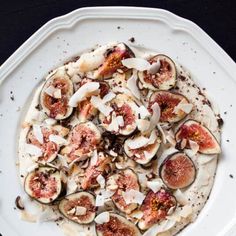 a white plate topped with sliced figs and cheese