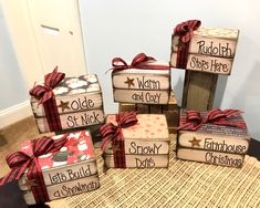 six wooden blocks with christmas sayings and bows on them sitting on a table in front of a door