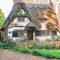 a white house with a thatched roof