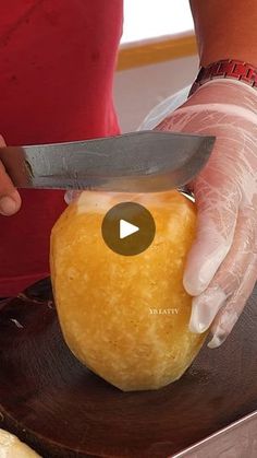 a person cutting an apple with a knife